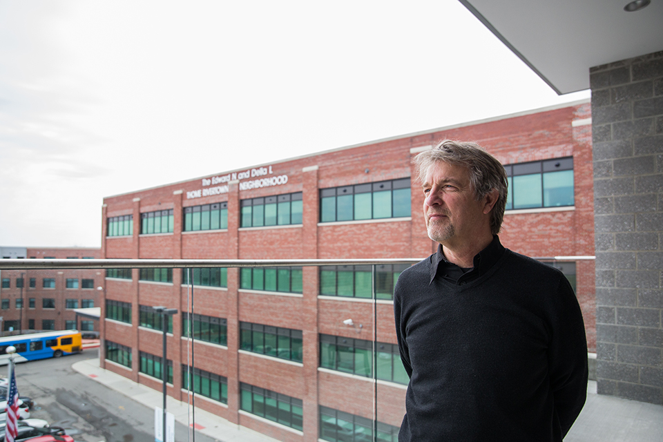Brian Carnaghi, vice president of Presbyterian Villages, stands on the Weinberg Green House patio at the Thome Rivertown development. Carnaghi and David Miller, vice president at Presbyterian Villages, spearheaded the effort to build the complex for low-i