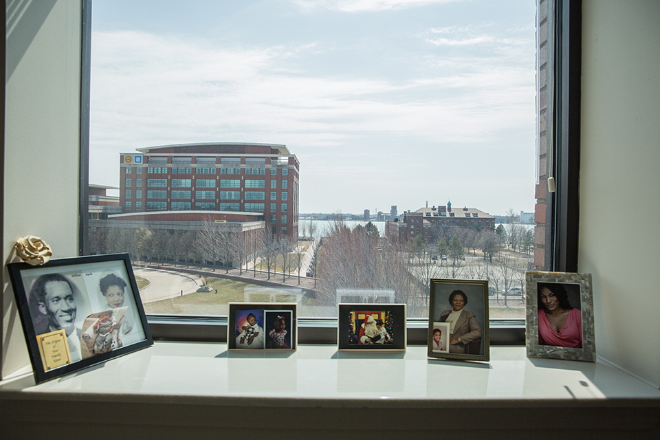 Photographs of Richardson's family and her late husband sit inside the windowsill of her apartment's living room, which overlooks the Detroit River.