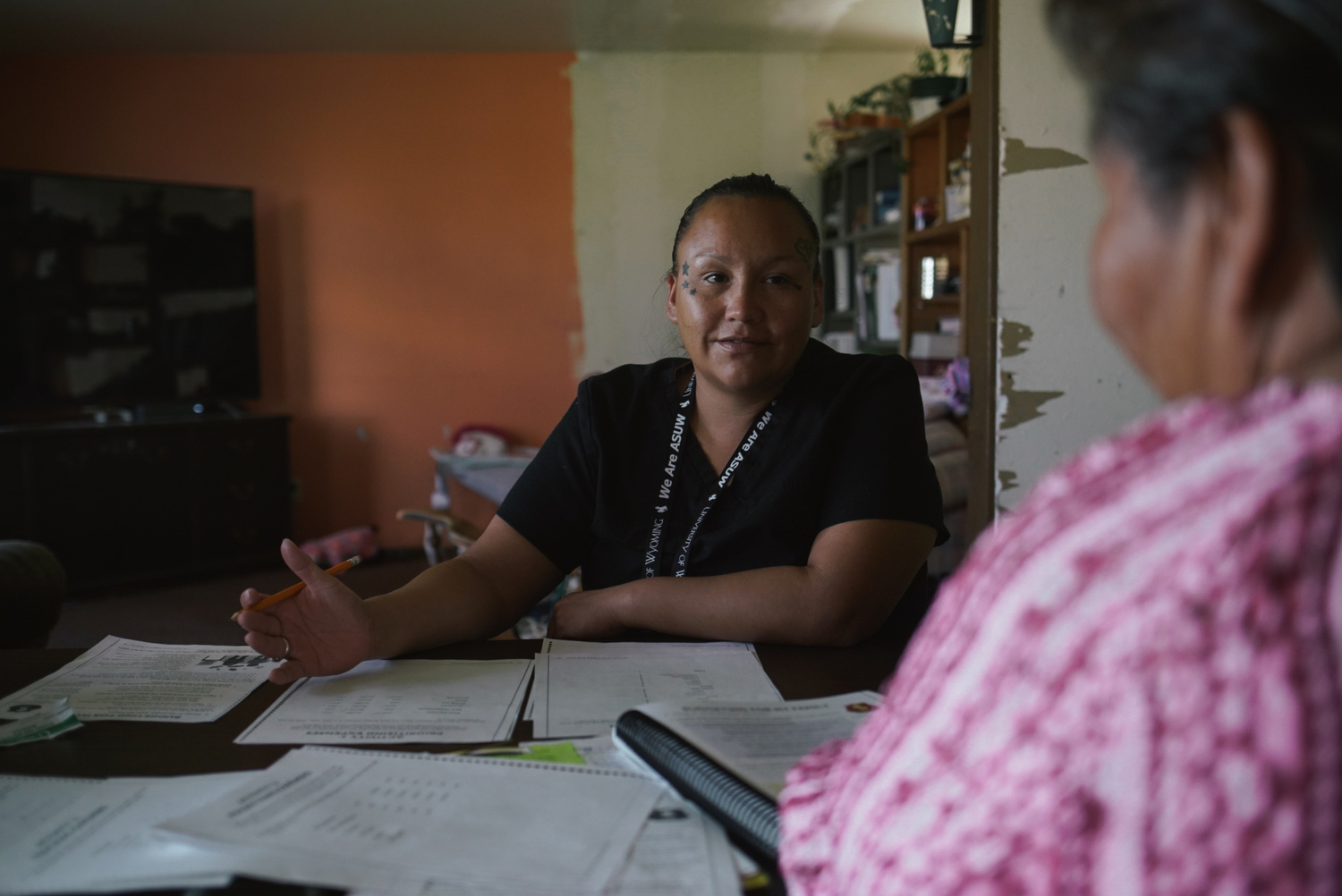 Desirae goes over budgeting worksheets with Elsie Charging Crow, a home educator with Wind River’s Family Spirit home visiting program. Elsie, an elder on the Wind River Indian Reservation, teaches parents in the program about healthy child development, life skills, and Northern Arapaho traditions around parenting.