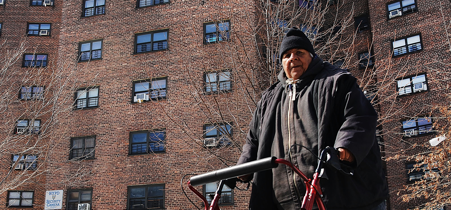 A man walks by the Farragut Houses, a public housing project in Brooklyn on March 16, 2017 in New York City.