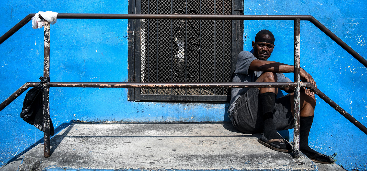 Man sits outside his house