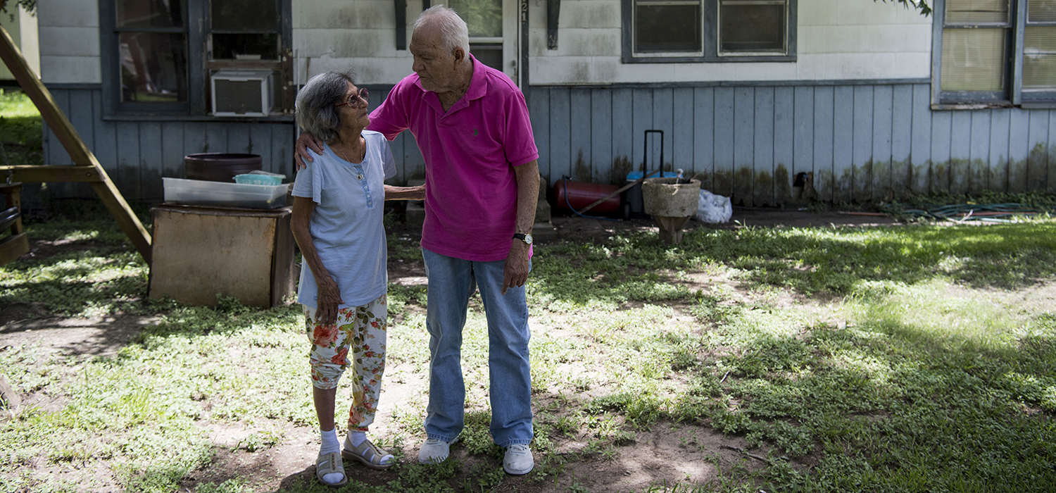 Janie and Jessie Peña stand for a portrait in front of their home, which was destroyed in Hurricane Harvey, in Wharton, Texas on July 1, 2018.