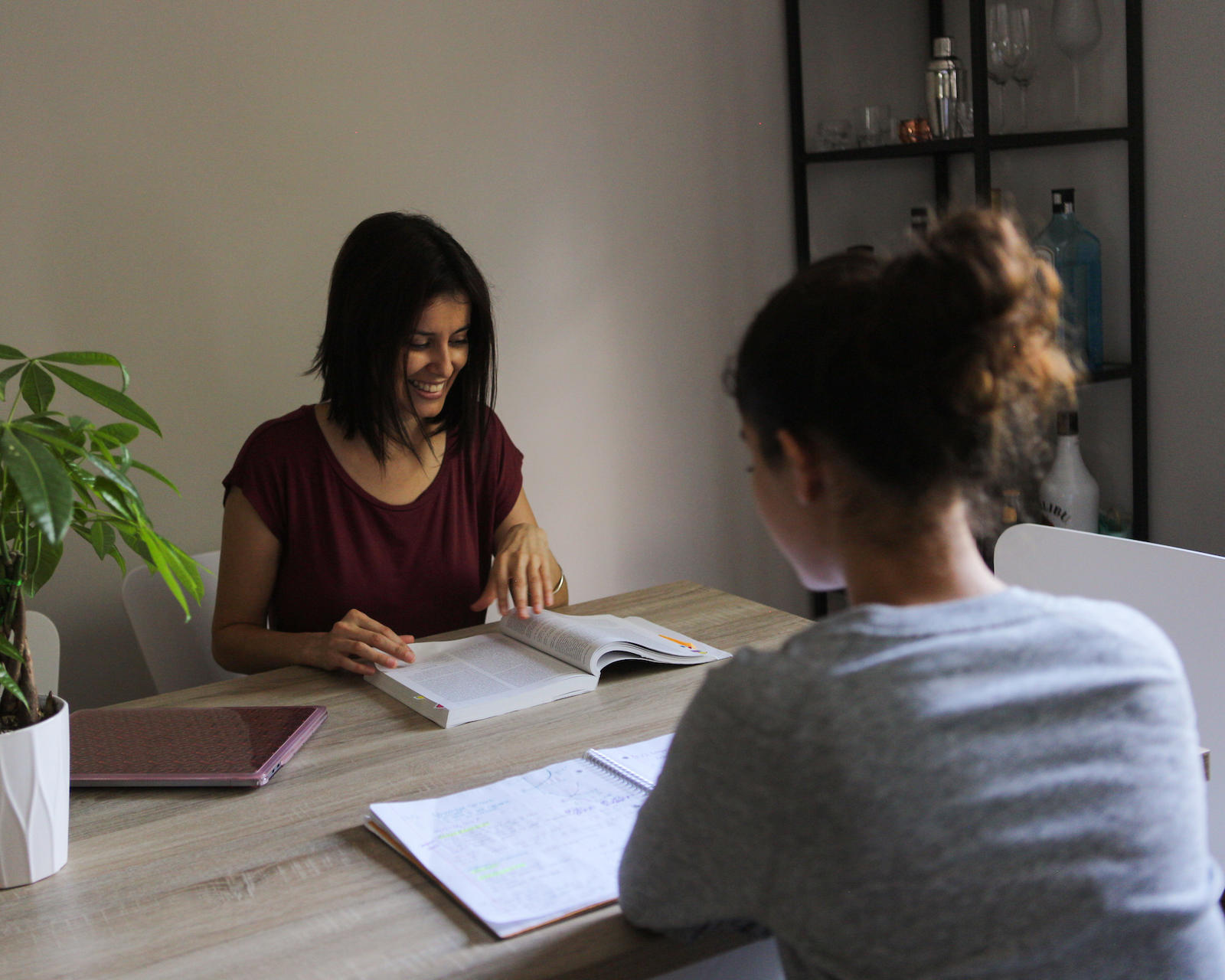 Coral Castro and her daughter, Diana, study together at their dining table.