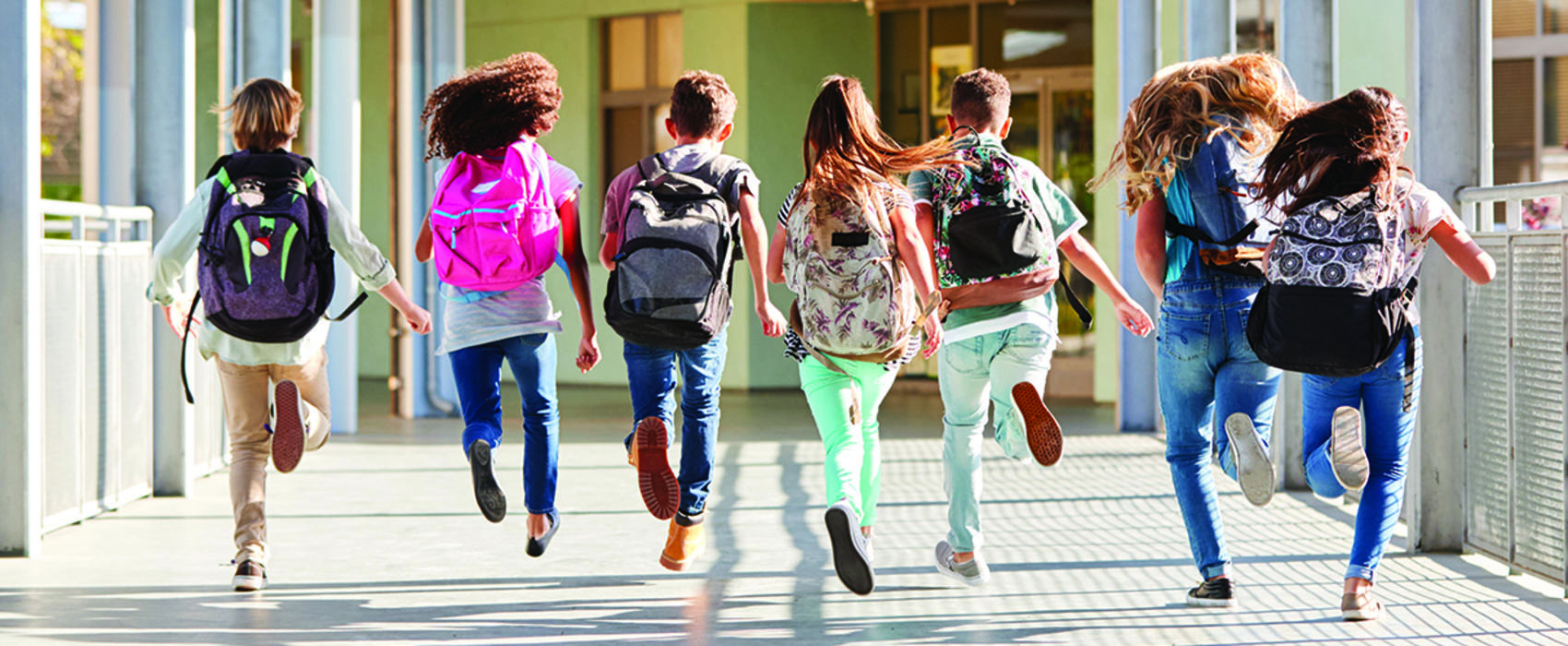 Group of children running to class