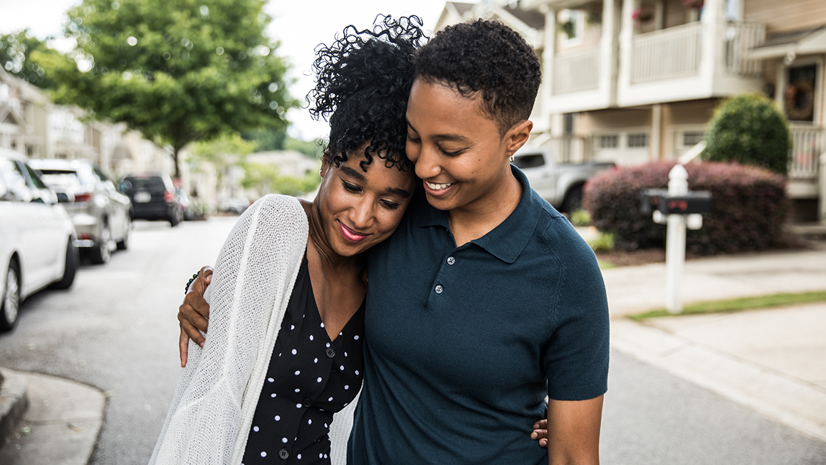 Two people hugging.