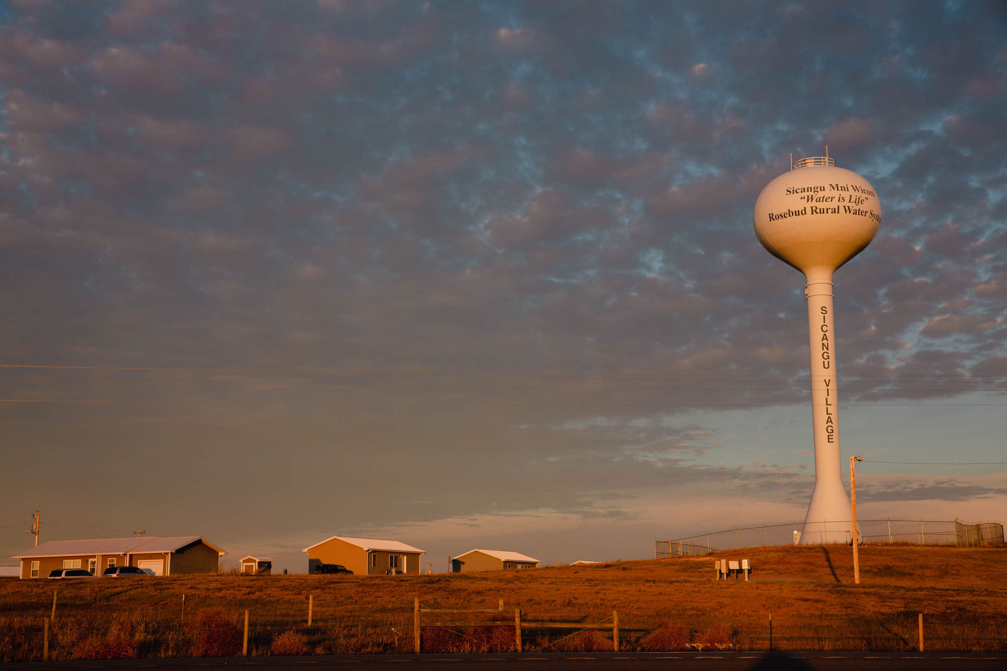 Sicangu Village, a new housing development, sits under a water tower. 