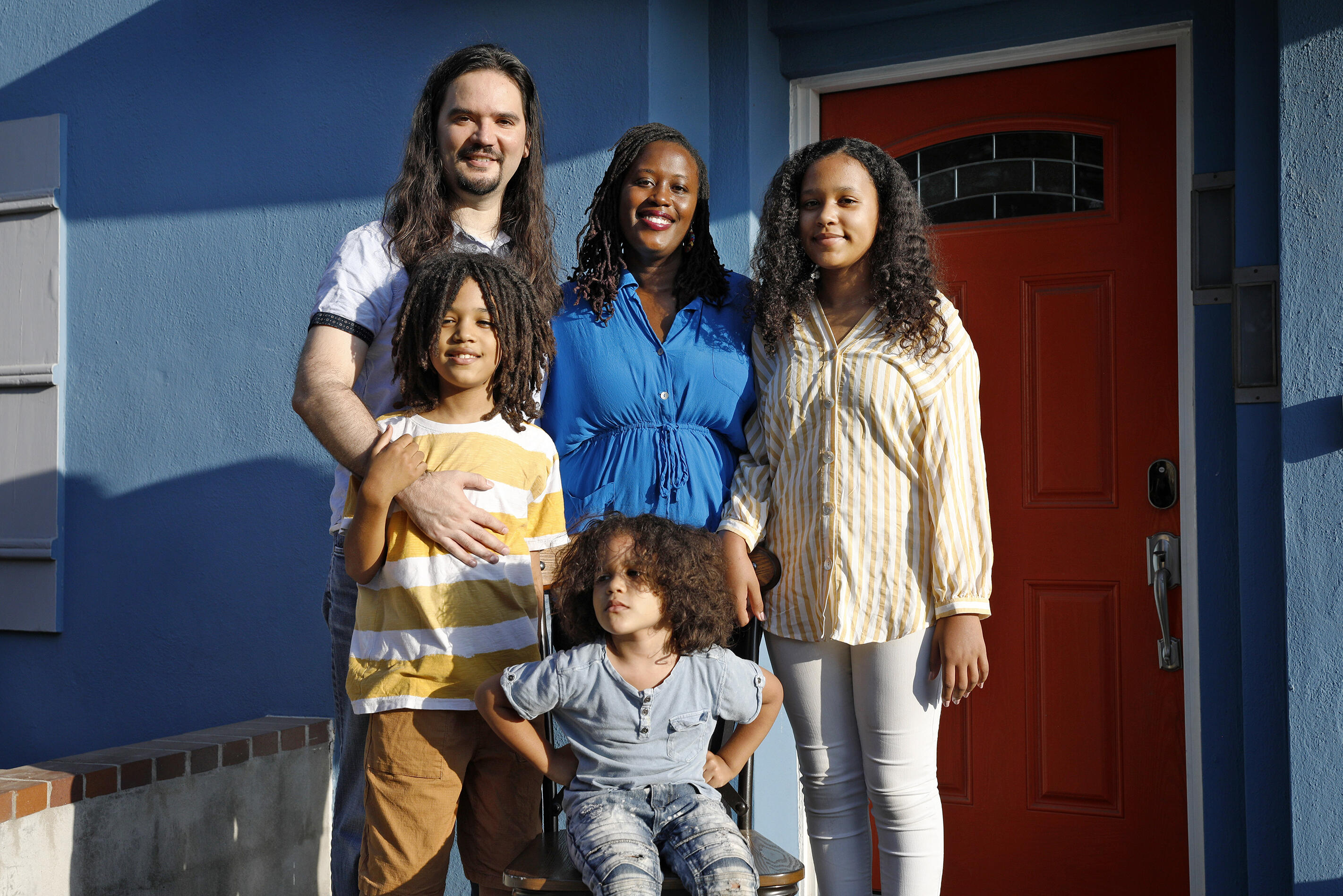 Sara Prada, her husband, Ricardo Prada, and their three children stand outside their home in Hayward, California.