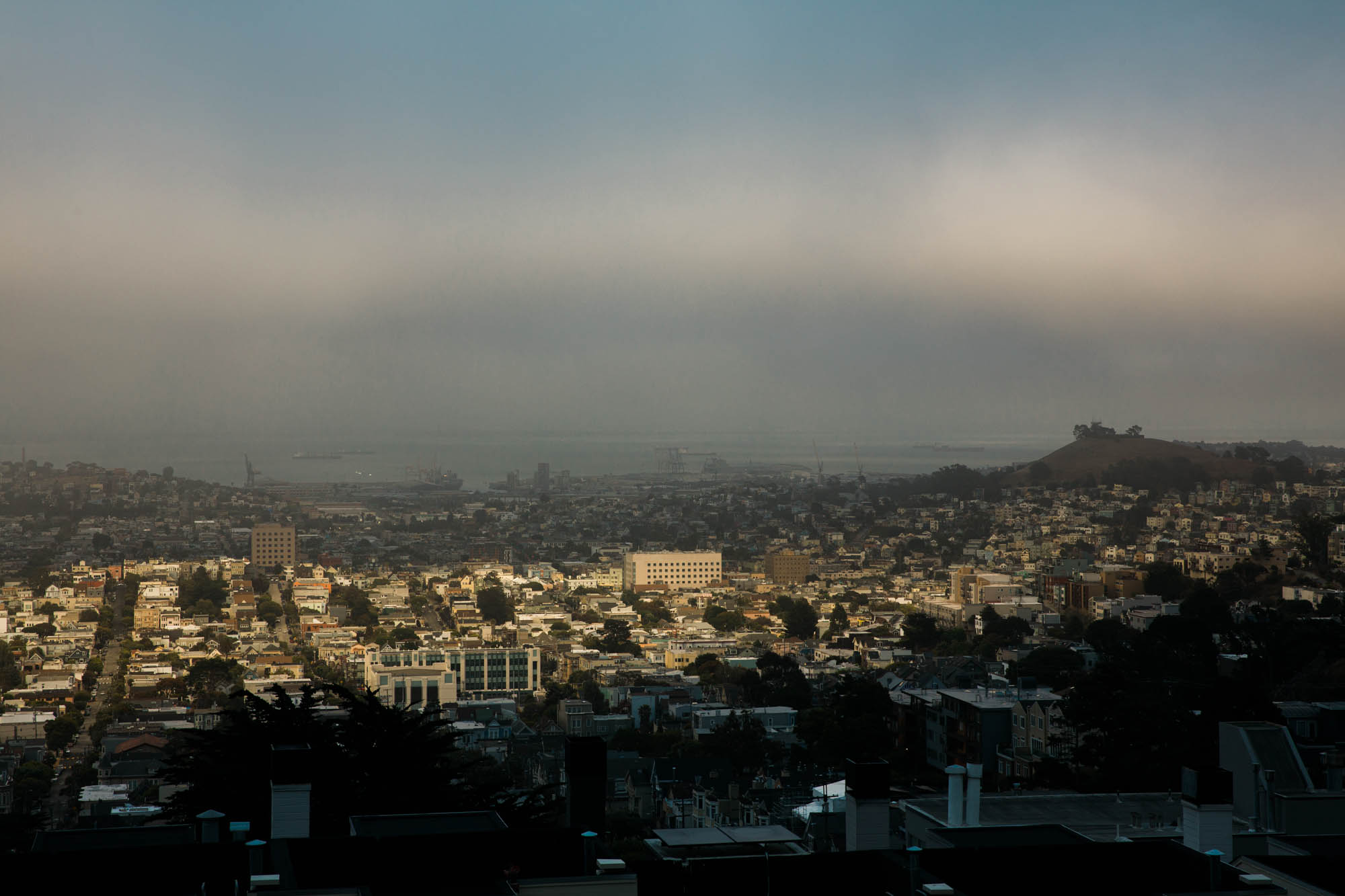 The sun breaks through the fog and shines on a residential neighborhood of San Francisco.
