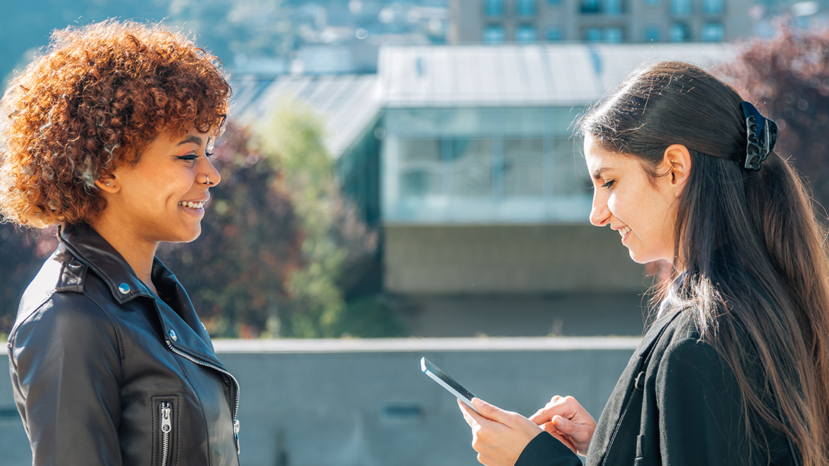 business woman on the street with device interviewing