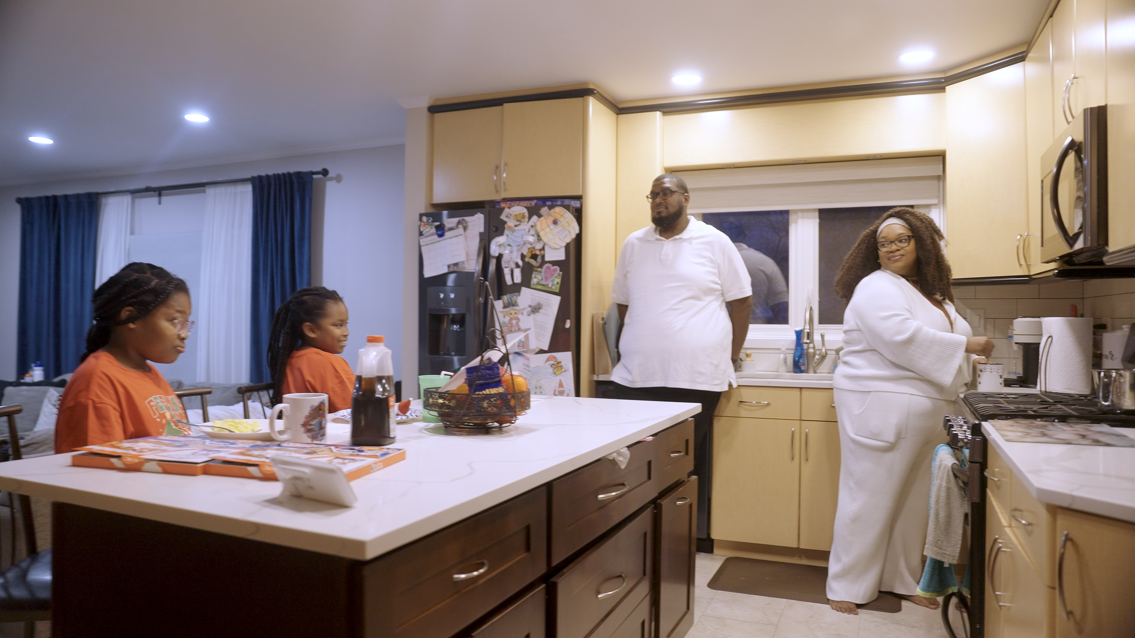 Courtney Brunson and his wife make breakfast for two of their children.