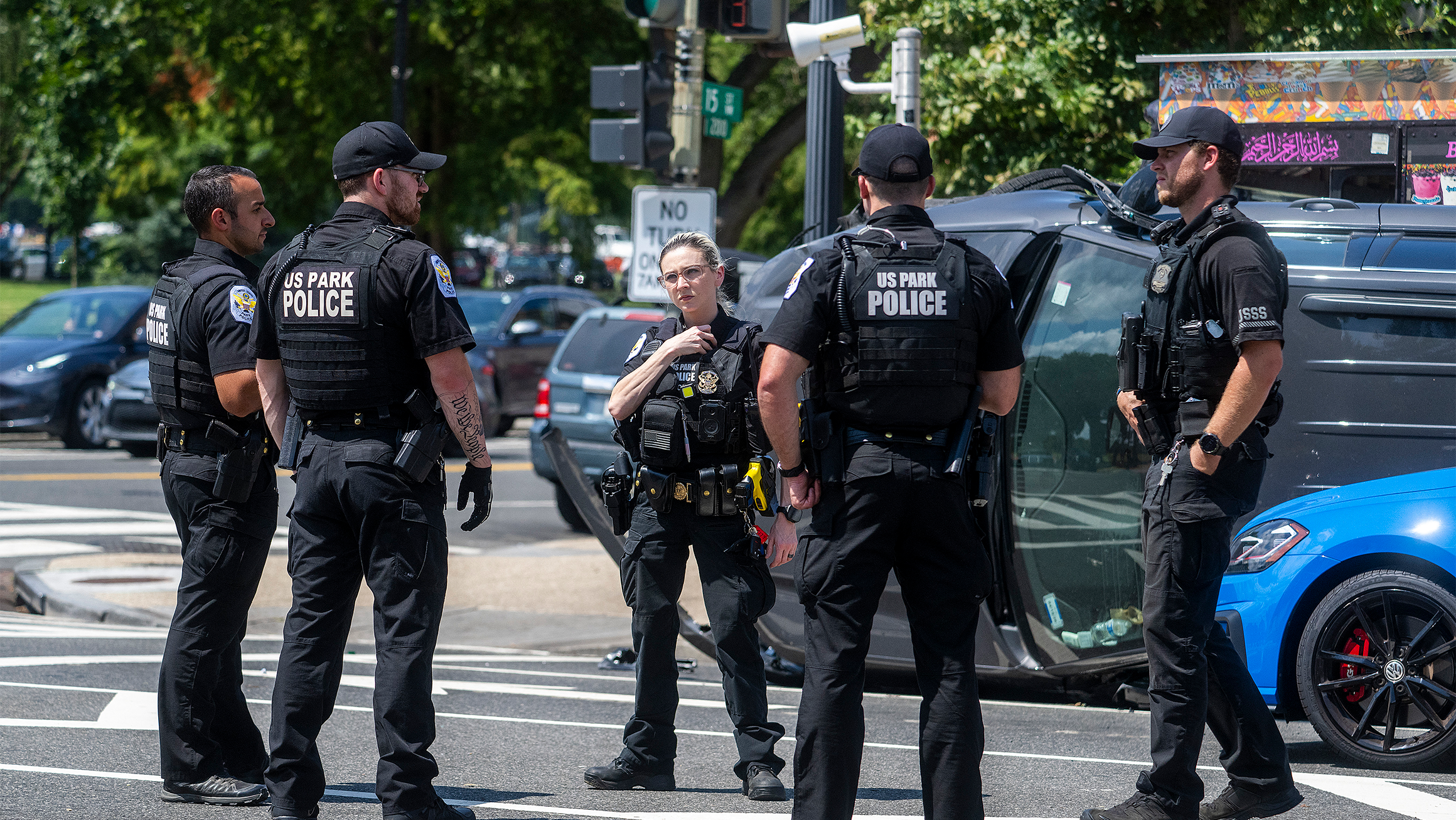 A group of police officers in the middle of a street. 