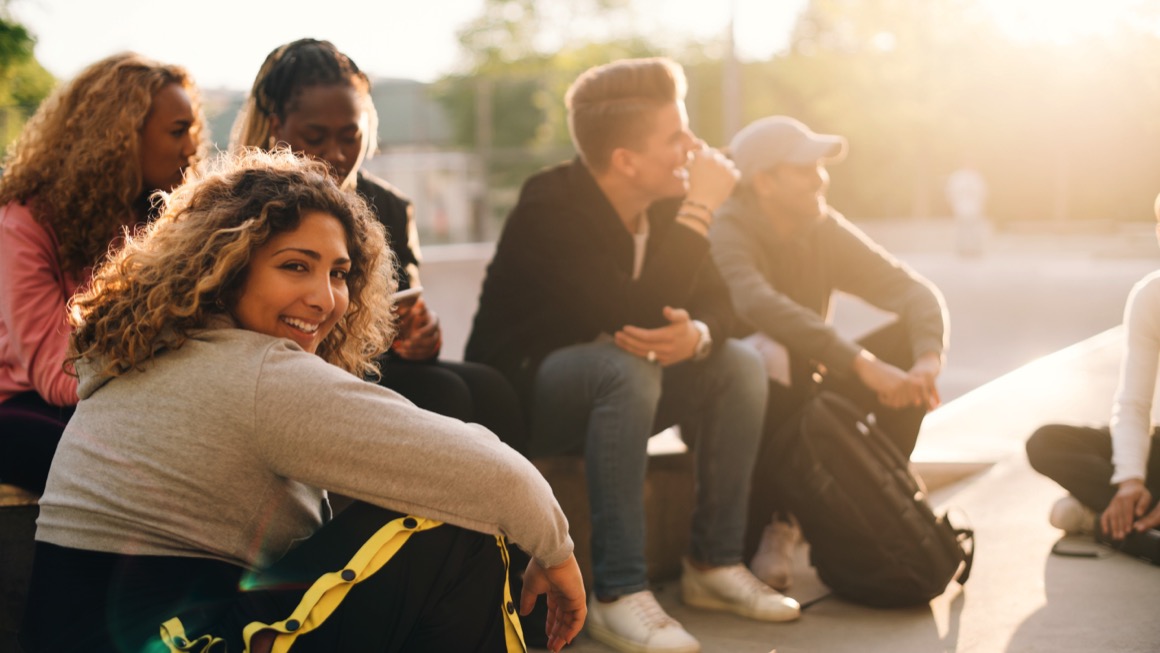 High school students sit together outdoors.