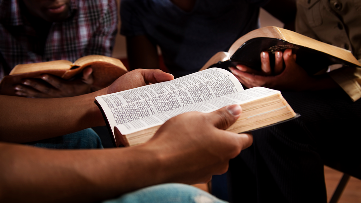 Hands holding a bible open
