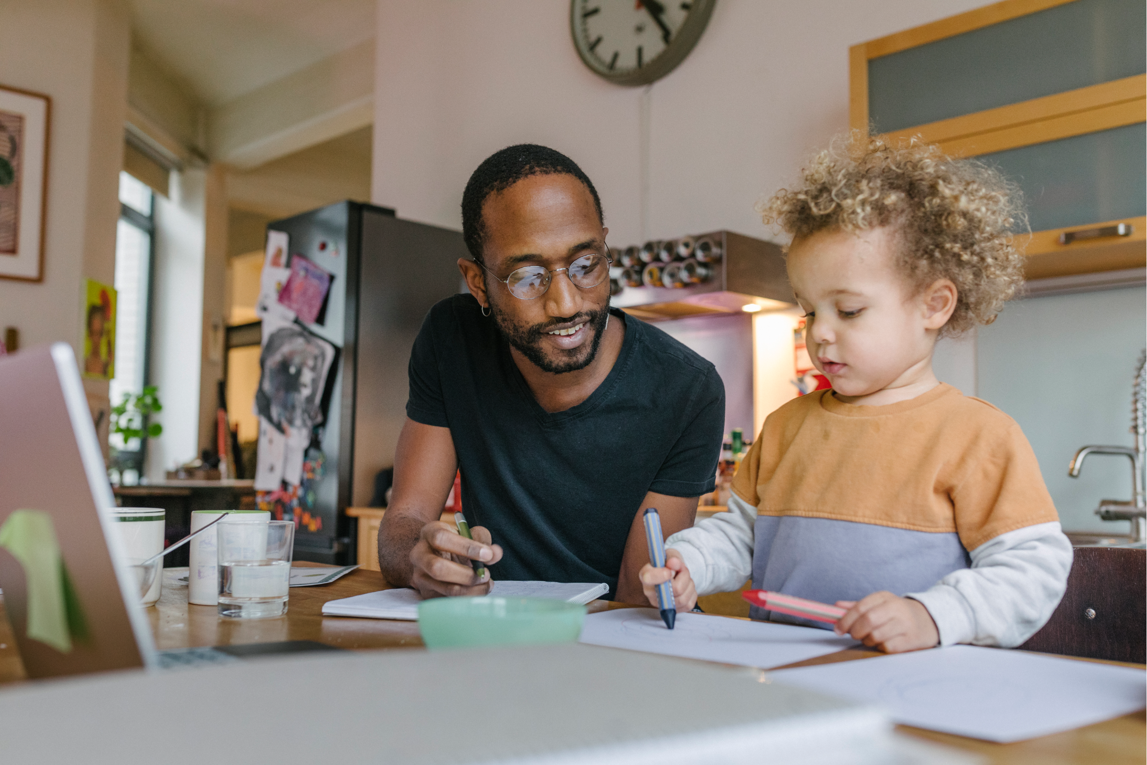 A father and son drawing together.