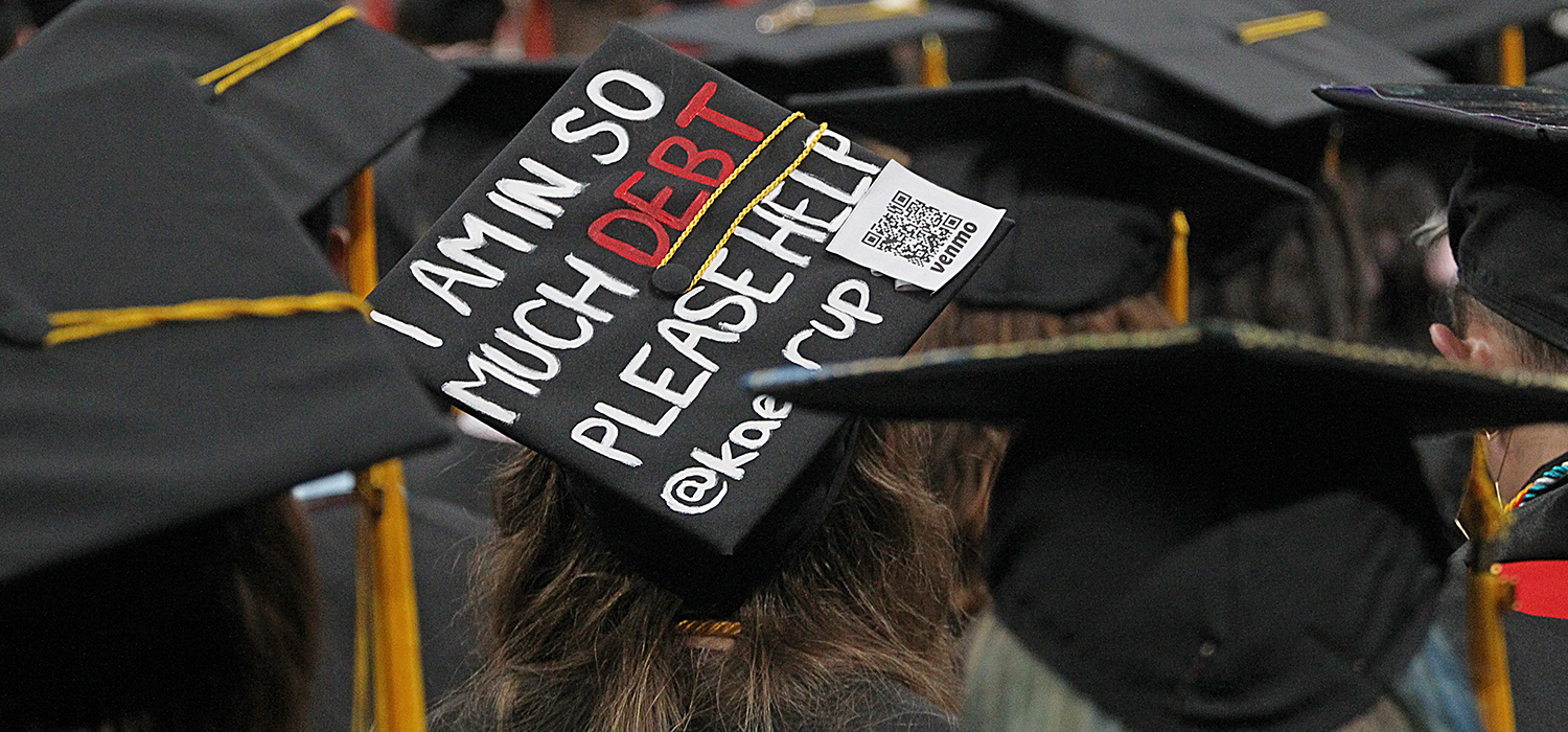 College graduation cap reads "I am in so much debt please help"