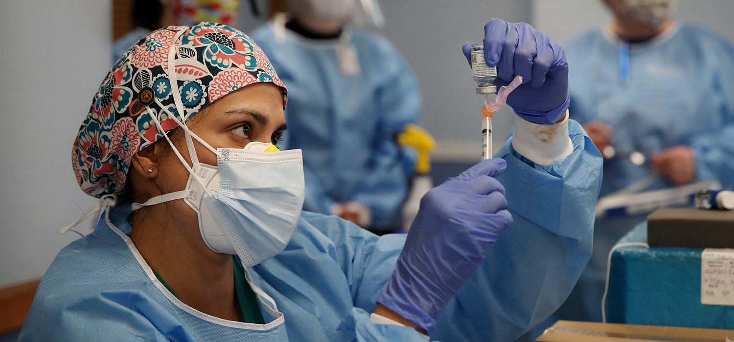 Physician's assistant prepares doses of the Moderna COVID-19 vaccine