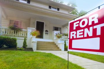 photo of house with for rent sign outside of it