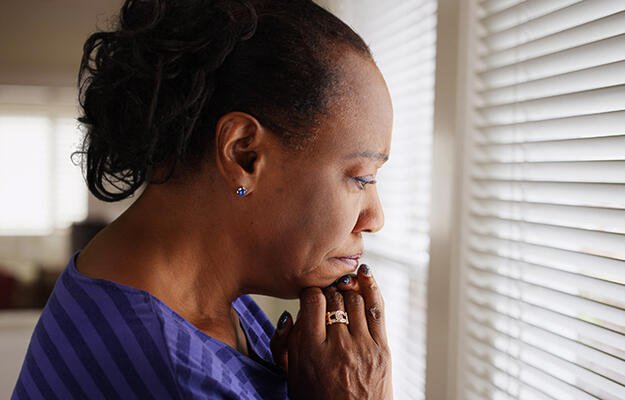 Woman looks out window