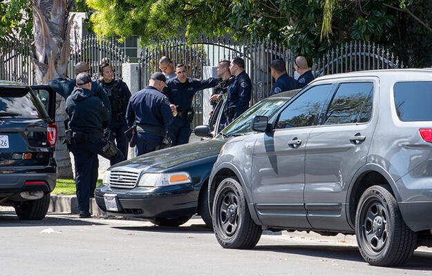 Police gather in a neighborhood