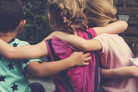 Photo of children with linked arms