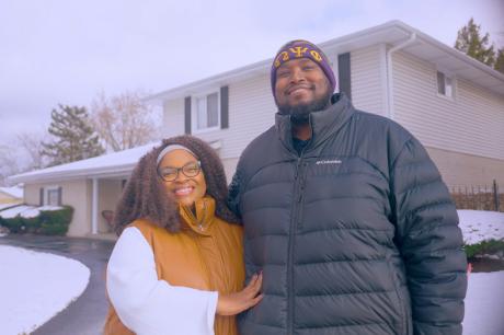 photo of black couple together in front of home