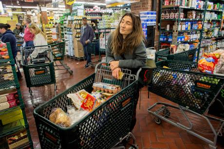 A mother stocks up on essential long term food supplies
