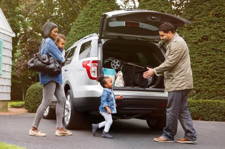 A family getting into their car.