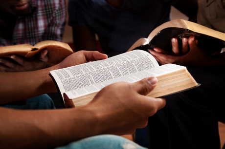 Hands holding a bible open