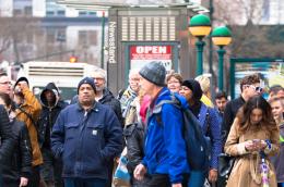 Busy city street scene of diversity of pedestrian people crossing the street.