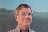 A photo of Andrew Davidson. Slgiht smile, greying hair, glasses.