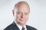 A photo of Alex Pollock. Slight smile, suit and tie.