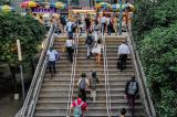 Pedestrians climbing stairs to an outdoor food court in New York City.